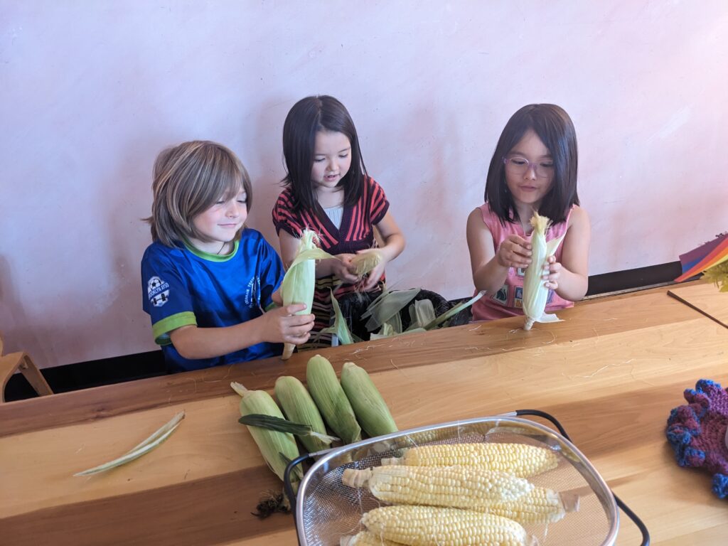 children-shucking-corn